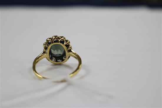 An 18ct gold, diamond and pale blue/green zircon set oval cluster ring, size P.